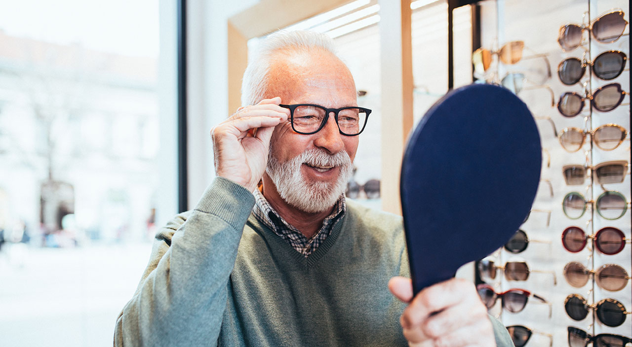 man trying on glasses frames